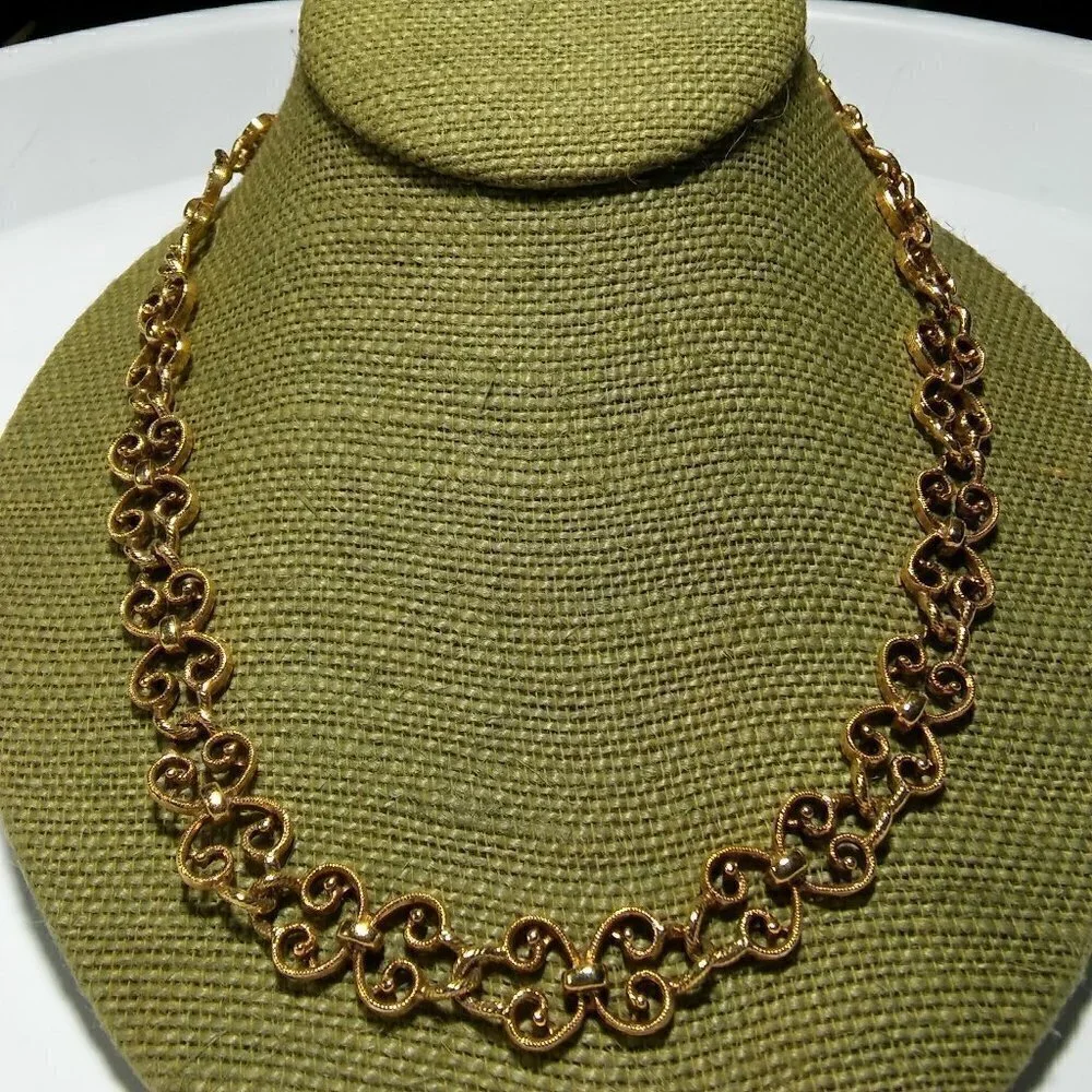 Women`s gold tone swirl necklace. 19 inches long.